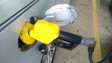 Insertion of the nozzle and pumping gasoline into vehicle at the gas station. Stock Footage 87483462