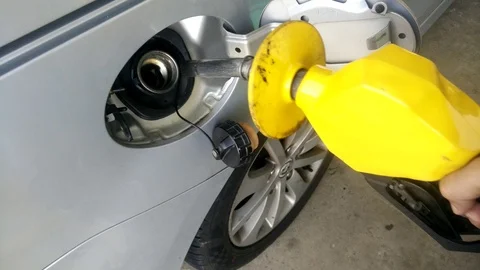 Insertion of the nozzle and pumping gasoline into vehicle at the gas station. Stock Footage 87483555