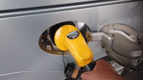 Insertion Of The Nozzle And Pumping Gasoline Into Vehicle At The Gas Station. Stock Footage 106671719