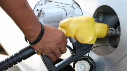 Inserts a fuel gun in a gas tank to refuel a car at the petrol station vehicle 库存影片 336569727