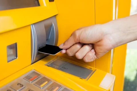 Inserts a plastic card into the ATM Stock Photos
