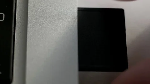Inserts the SD card into the laptop Video stock 84848363
