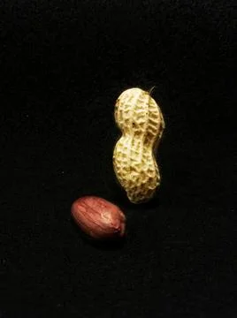 Inshell peanuts and kernel on a black background Foto stock
