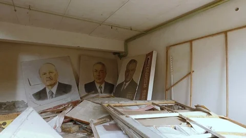Inside the abandoned premises are scattered portraits. Ukraine Stock Footage 74729945