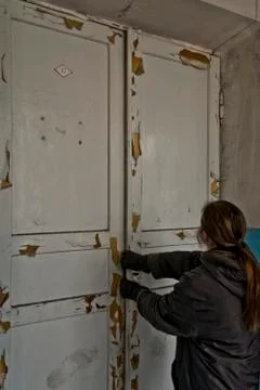 Inside the abandoned Soviet school. try to open door Stock Photos