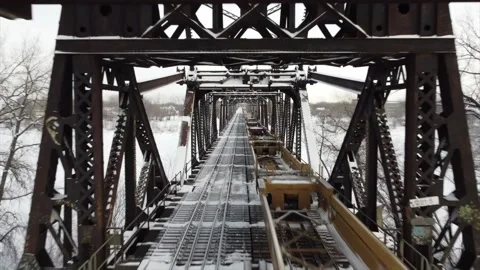 Inside active train bridge in winter - Drone Stock Footage 169888039