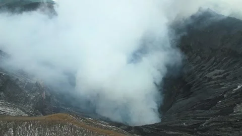 Inside of active volcano crater emitting thick white smoke into sky Stock Footage 295763762