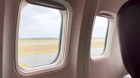 Inside airplane window view of runway during takeoff motion. Stock Footage 333163152