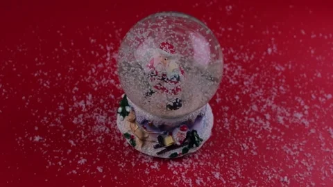 Inside a ball with snow, Santa on a red background Christmas and New Year Stock Footage 167612384