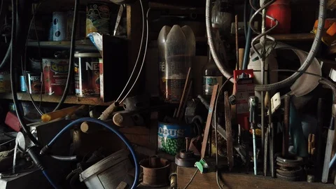 Inside the barn. On the shelves in the barn is all sorts of different trash. Stock-Footage 117100696