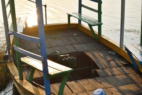 Inside of a boat with a motor captured during sunset Foto stock