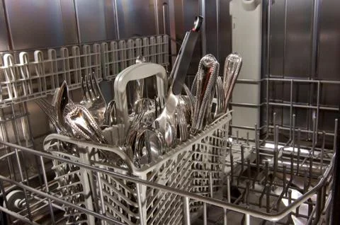Inside bottom drawer of nearly empty dishwasher Stock Photos