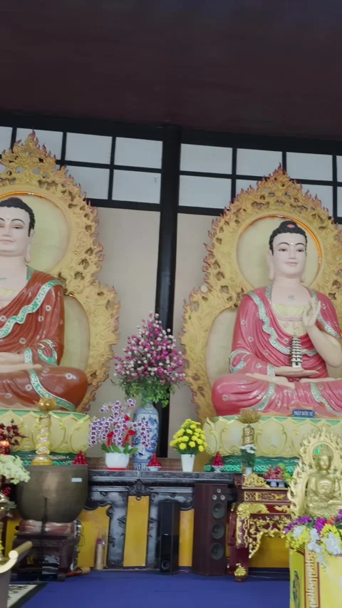 Inside a Buddhist temple with statues of Buddha and deities,  Da Lat, Vietnam Stock Footage 334154811