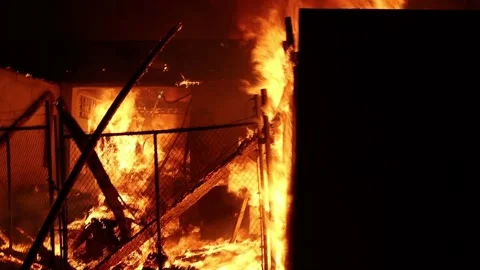 Inside of a building set on fire, chaos riots an loitering after protest Vídeos de archivo 138537553