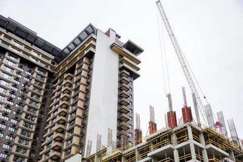 Inside building sites under construction and cranes with blue sky background. Stock Photos