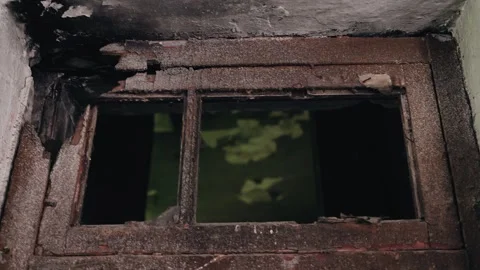 Inside the building, you can see a small window above an old broken door Stock Footage 244312625