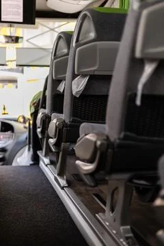 Inside a bus, empty seats are arranged in neat rows. The bright interior in.. Stock Photos