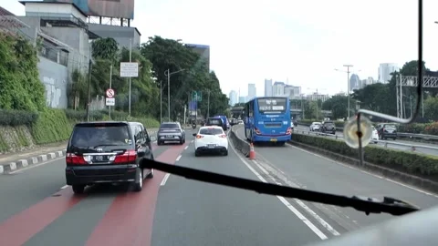 Inside the bus front seat around Jakarta street, Capitol of Indonesia. Stock Footage 172396890