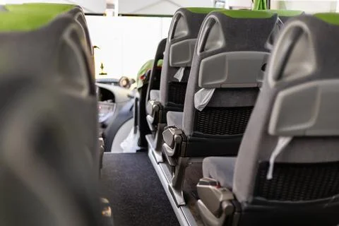 Inside a bus, the scene captures empty, modern seats arranged tidily along .. Foto stock
