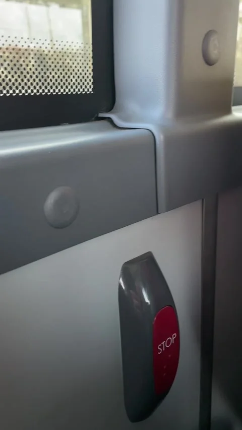 Inside bus with stop button. Closeup of bus control panel and window Video stock 335433596