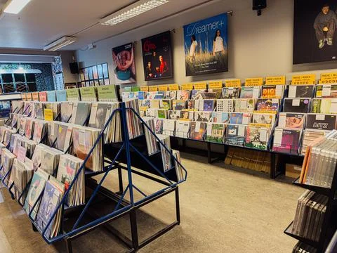 Inside a bustling vinyl store with rows of records and colorful display poste Stock Photos