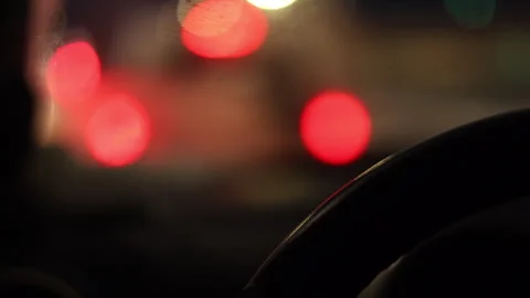 Inside a car with defocused city lights glowing background Stock Footage 325689391