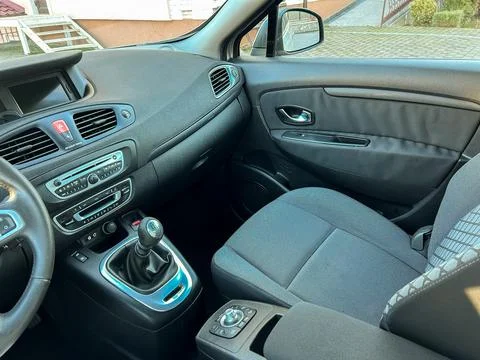 The inside of a car displays the dashboard with controls, a steering wheel, a Stock Photos