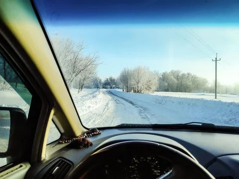Inside the car. driver behind the wheel. drive a car. journey. bad roads. by  Stock Photos