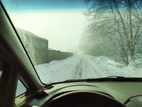 Inside the car. driver behind the wheel. drive a car. journey. bad roads. by  Foto stock