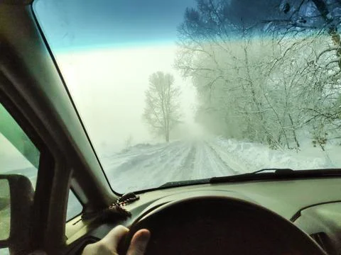 Inside the car. driver behind the wheel. drive a car. journey. bad roads. by  Stock Photos
