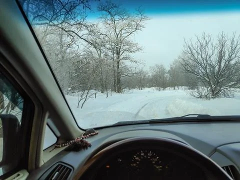 Inside the car. driver behind the wheel. drive a car. journey. bad roads. by  Stock Photos
