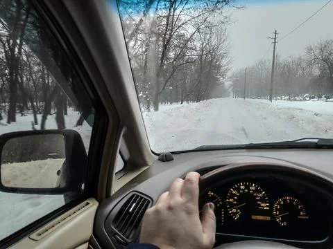 Inside the car. driver behind the wheel. drive a car. journey. bad roads. by  Photos