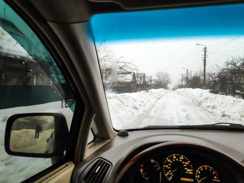 Inside the car. driver behind the wheel. drive a car. journey. bad roads. by  Stock Photos