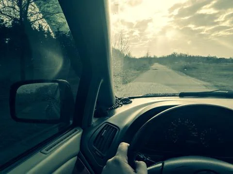Inside the car. driver behind the wheel. drive a car. journey. bad roads. by  Stock Photos
