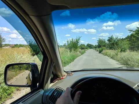 Inside the car. driver behind the wheel. drive a car. journey. bad roads. by  Stock Photos