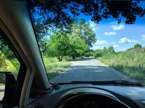 Inside the car. driver behind the wheel. drive a car. journey. bad roads. by  Stock Photos