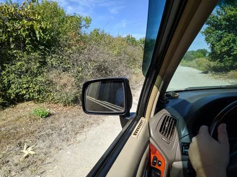 Inside the car. driver behind the wheel. drive a car. journey. bad roads. by  Stock Photos