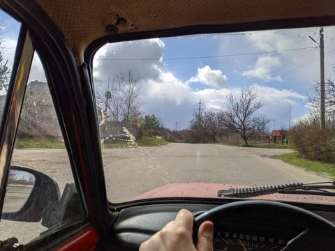 Inside the car. driver behind the wheel. drive a car. journey. bad roads. by  Fotos de archivo