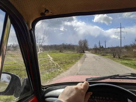 Inside the car. driver behind the wheel. drive a car. journey. bad roads. by  Фото