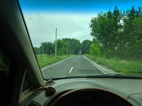 Inside the car. driver behind the wheel. drive a car. journey. bad roads. by  Foto stock