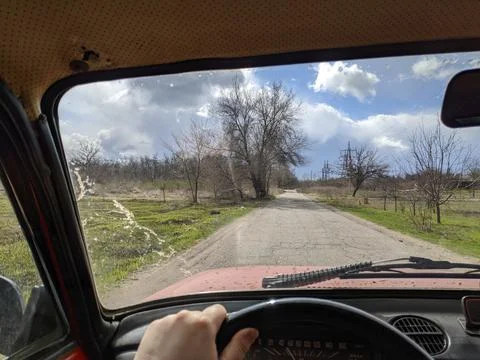 Inside the car. driver behind the wheel. drive a car. journey. bad roads. by  Stock Photos