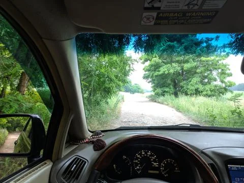 Inside the car. driver behind the wheel. drive a car. journey. bad roads. by  Stock Photos