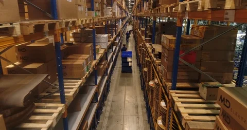 Inside the car factory warehouse. Group of workers are walking along the shelves Stock Footage 87389634