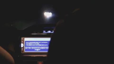 Inside a Car GPS Module is On.The car drive time in the night Stock Footage 148610567