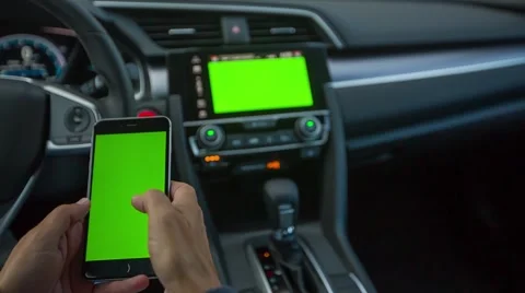 Inside car typing on phone and car touchscreen Stock Footage 66207119
