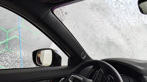 Inside Car View Of Man Washing Windshield And Side Mirror At Service Station Stock Footage 336638094