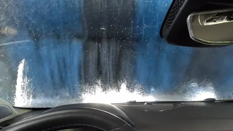 Inside car wash with rotating brushes Stock Footage 332064814