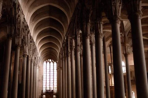 Inside the cathedral, view of the tall columns with arched vaults. Digital il Ilustración de archivo