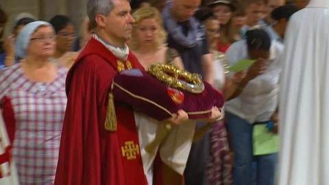 Inside Catholic Notre Dame Cathedral in Paris, religious visitors kiss the holy Stock Footage 106632724