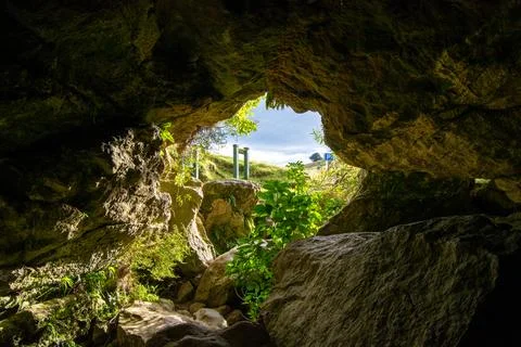 Inside a Cave with a View of Lush Landscape Stock Photos